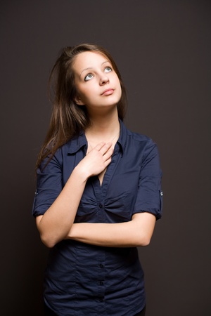Portrait of an attractive slender young brunette woman pondering.の写真素材