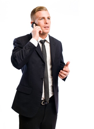 Half legth portrait of a successful young businessman on his cellphone.の写真素材