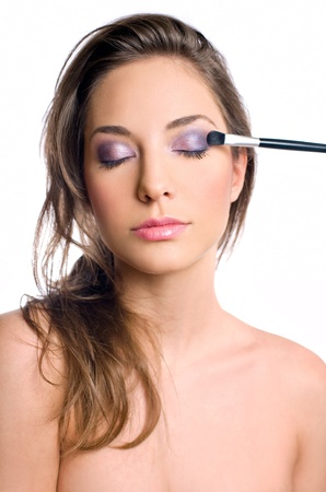 Gorgeous young brunette woman getting an elegant makeup.の写真素材