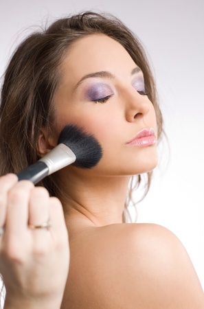 Gorgeous young brunette woman getting an elegant makeup.の写真素材