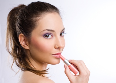 Portrait of a sensual young brunette woman with pink lipstickの写真素材