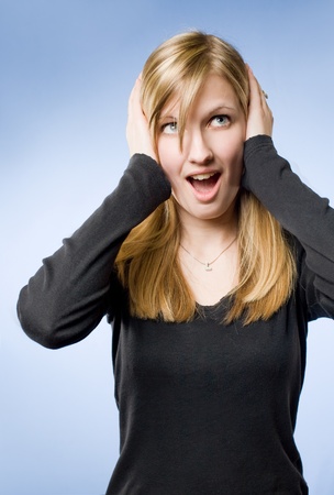 Shocking news, portrait of a beautiful young woman with extreme surprised expression.の写真素材