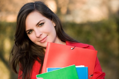 Closeup portrait of a colorful friendly young student girl outdoors の写真素材