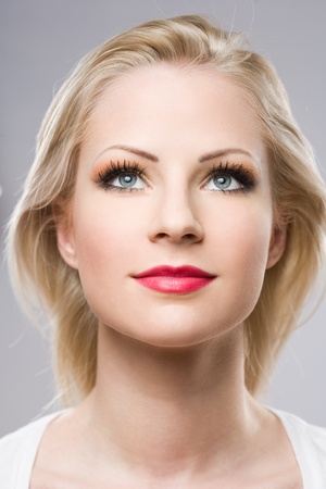Clean portrait of a beautiful relaxed blond woman in elegant makeup.の写真素材