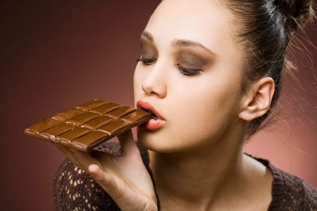 Never enough chocolate, striking young brunette with dessert overload の写真素材