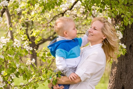 Portrait of a young mother and her son outdoors in nature at spring.の写真素材