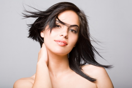 Portrait of a sensual young brunette with windswept hair.の写真素材