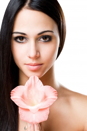 Portrait of a striking brunette beauty with fresh flower.の写真素材