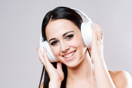 Gorgeous brunette music lover wearing bright white headhones の写真素材