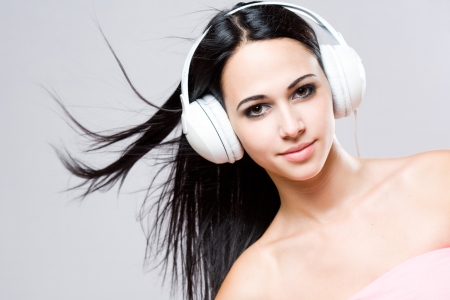 Gorgeous brunette music lover wearing bright white headhones の写真素材