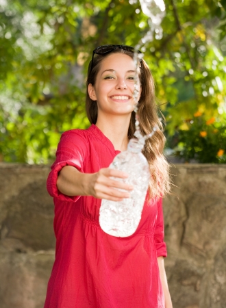 Outdoors water fun with gorgeous young brunette girl.の写真素材