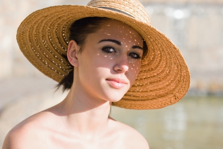 Closeup portrait of a summer brunette beauty in straw hat.の写真素材