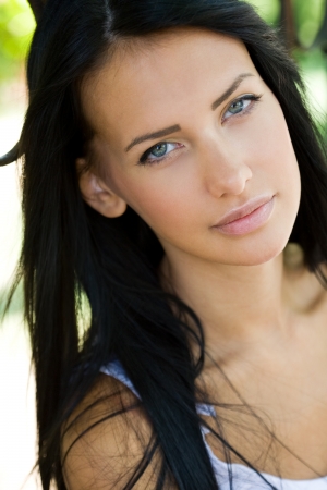 Outdoors closeup portrait of a young tanned brunette beauty.の写真素材