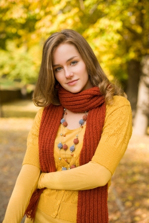 Fall color harmony, fashionable gorgeous young blond outdoors in the park.の写真素材