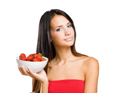 Gorgeous slender young brunette woman with bowl of fresh strawberries.の写真素材