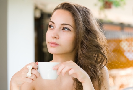 Coffee romance, portrait of a gorgeous young brunette woman.の写真素材