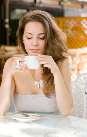 Portrait of a romantic looking hot coffee brunette lady.の写真素材
