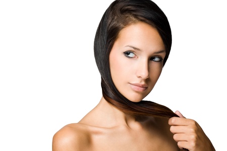 The hair check, portrait of a beautiful young brunette woman with shiny hair.の写真素材