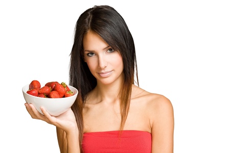Portrait of an attractive brunette woman with fresh strawberries.の写真素材