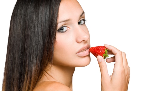 Portrait of a brunette beauty ready to bite into ripe strawberry.の写真素材