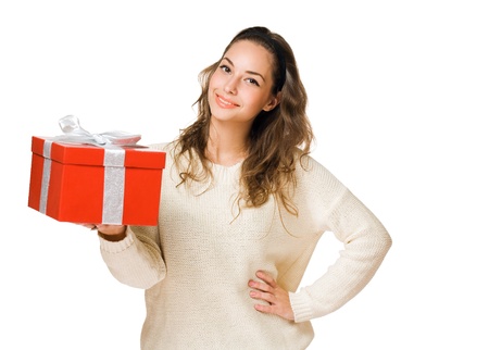 Cheerful friendly young brunette with red gift box isolated on white background.の写真素材