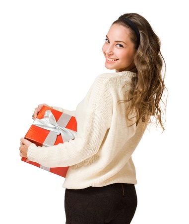Portrait of a beautiful young brunette woman holding a bright red gift box.の写真素材