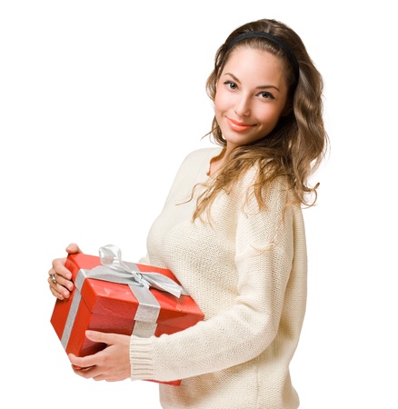 Cheerful friendly young brunette with red gift box isolated on white background.の写真素材