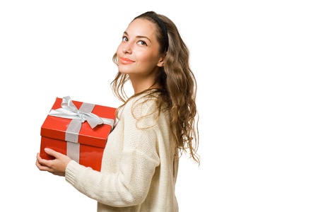 Cheerful friendly young brunette with red gift box isolated on white background.の写真素材