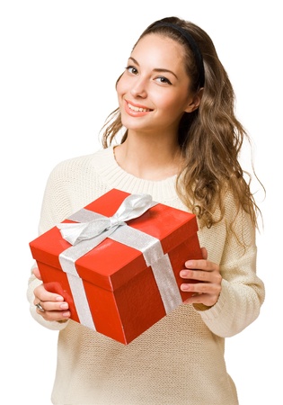 Portrait of a beautiful young brunette woman holding a bright red gift box.の写真素材
