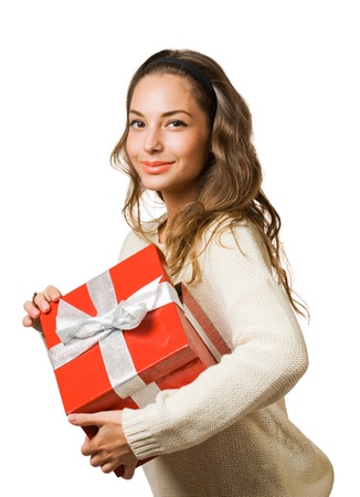 Portrait of a beautiful young brunette woman holding a bright red gift box.の写真素材