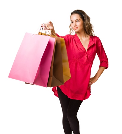 Beautiful young brunette woman with colorful shopping bags の写真素材