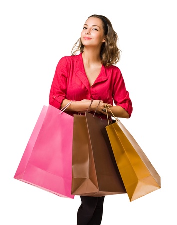 Cool friendly young brunette woman holding colorful shopping bags の写真素材