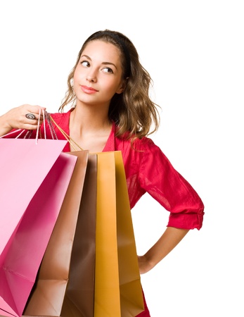 Beautiful young brunette woman with colorful shopping bags の写真素材