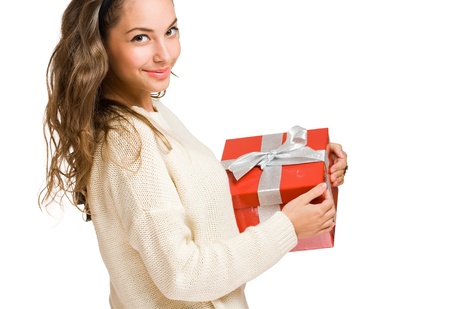 Portrait of a cute young brunette with bright red gift box の写真素材