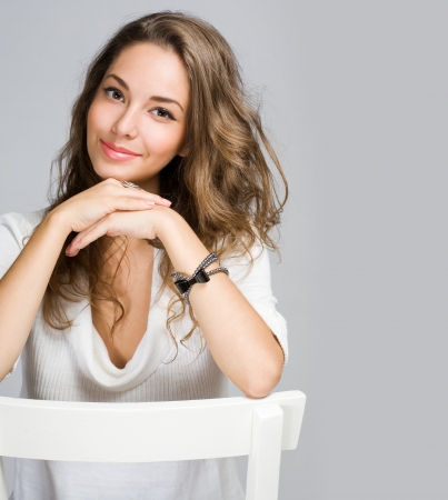 Portrait of a cheerful friendly young pensive brunette beauty の写真素材