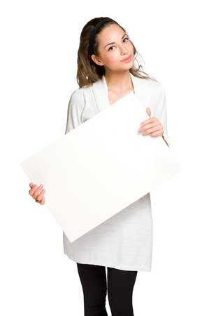 Portrait of a beautiful young brunette woman with blank billboard sheet の写真素材