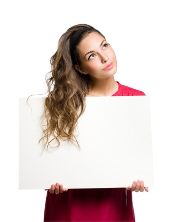Freindly young brunette beauty holding white blank banner の写真素材