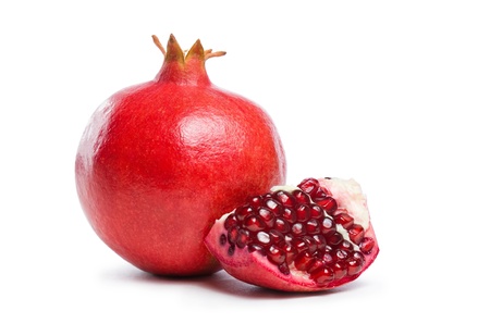 Studio shot of fresh ripe pomegranate whole and part with seeds.の写真素材