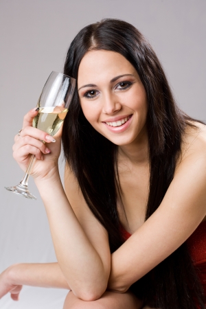 Gorgeous young brunette woman ready to celebrate with champagne.の写真素材