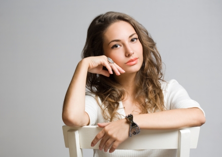 Studio portrait of friendly pensive young brunette beauty の写真素材