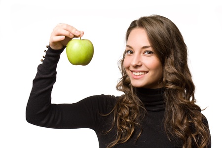 Portrait of a fit young brunette with juicy fresh green apple.の写真素材