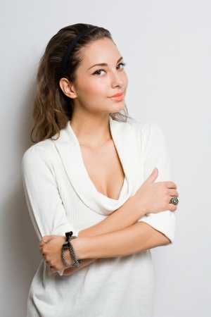 Studio portrait of cute fashionable young brunette dressed in white.の写真素材