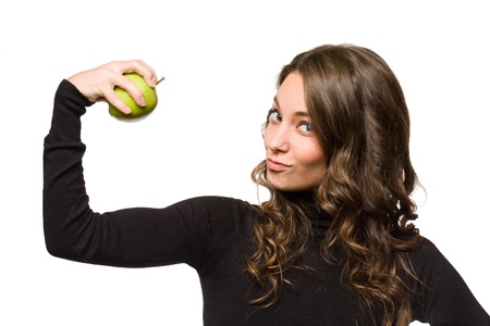 Gorgeous young brunette woman showing off fresh green apple.の写真素材