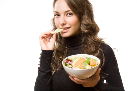 Portrait of healthy eating beautiful young brunette woman.の写真素材