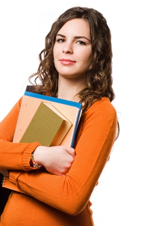 Attractive young brunette student girl with colorful exercise books.の写真素材
