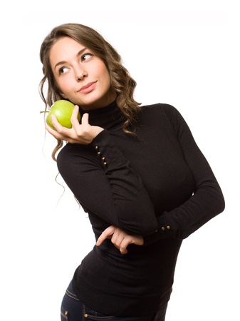 Portrait of gorgeous slender brunette woman holding juicy fresh apple.の写真素材