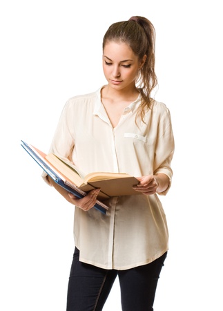Cute young brunette student girl reading a book.の写真素材