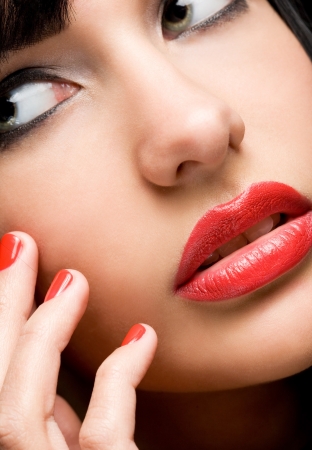 Semi abstract closeup portrait of gorgeous brunette with striking lip shine, focus on the lips の写真素材