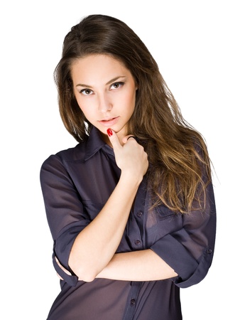 Striking young brunette beauty in pensive pose on white background の写真素材