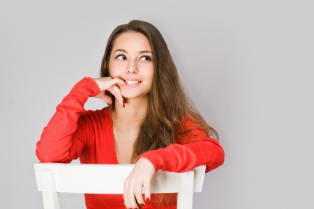 Portrait of sensual happy young brunette woman in red sweater の写真素材